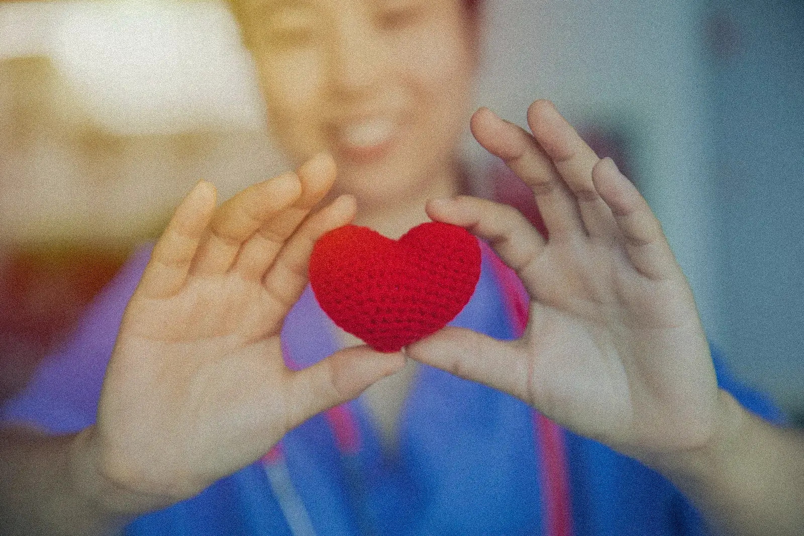 A hospice nurse with a hand resting gently on a patient's shoulder
